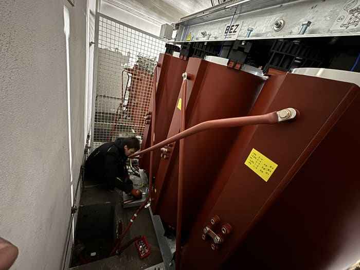 Technician connecting the terminals of the new transformer