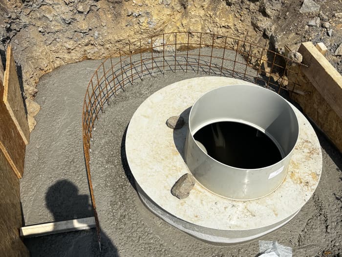 Shaft set on a concrete base with reinforcement in the open pit